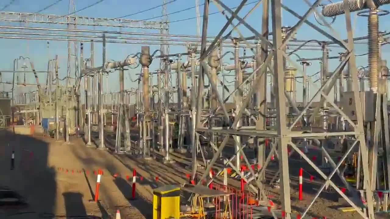 Slow pan across an energised high-voltage transmission substation